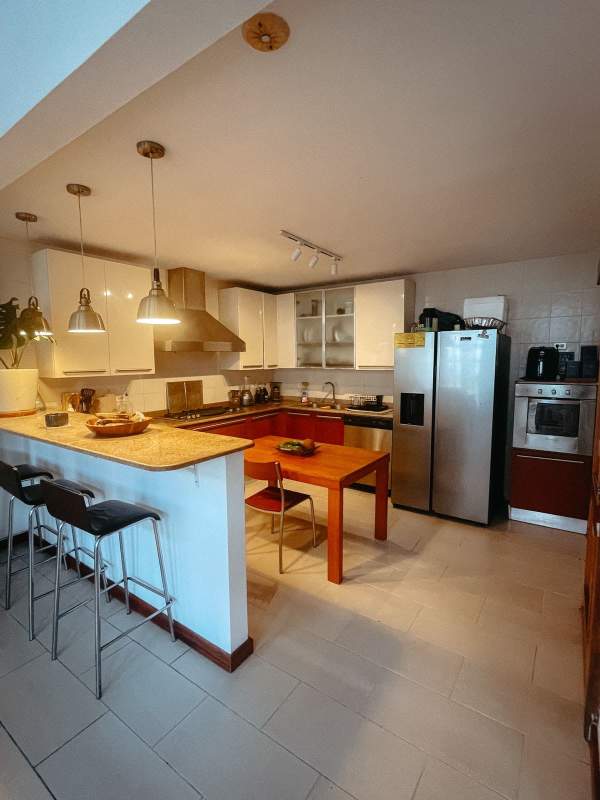 Spacious bedroom with vaulted ceiling, wooden floor, baby crib, office PH Casco Antiguo Panama