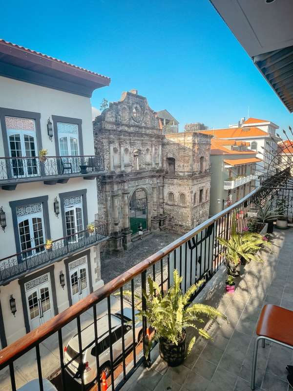 Long hallway with exposed stone wall modern stairs in PH Casco Antiguo Casco Viejo Panama