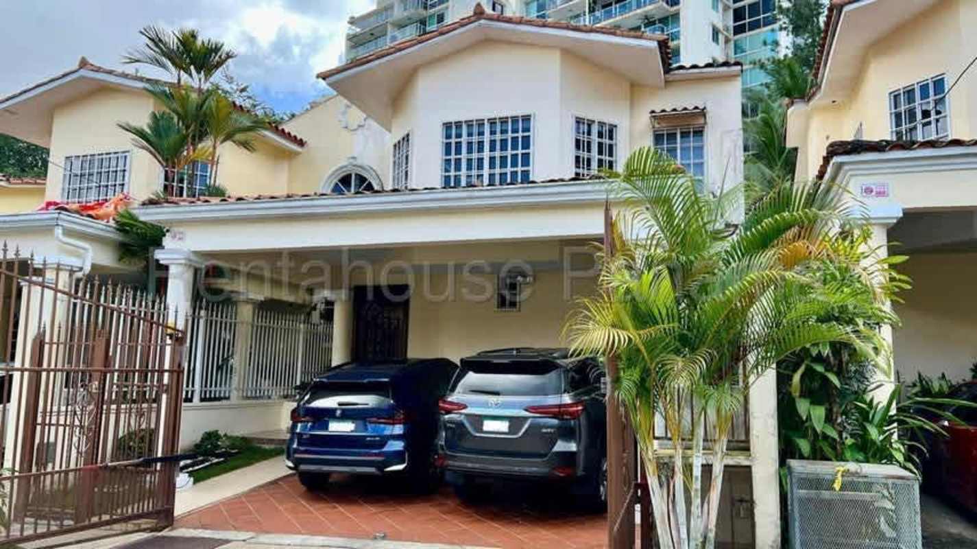 Exterior of two-story Mediterranean-style house with garage and tropical landscaping in Albrook Clayton Panama