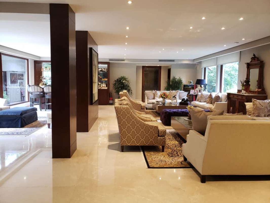 Spacious living room with grand piano, large windows, marble floors and luxury decor in Altos del Golf Panama