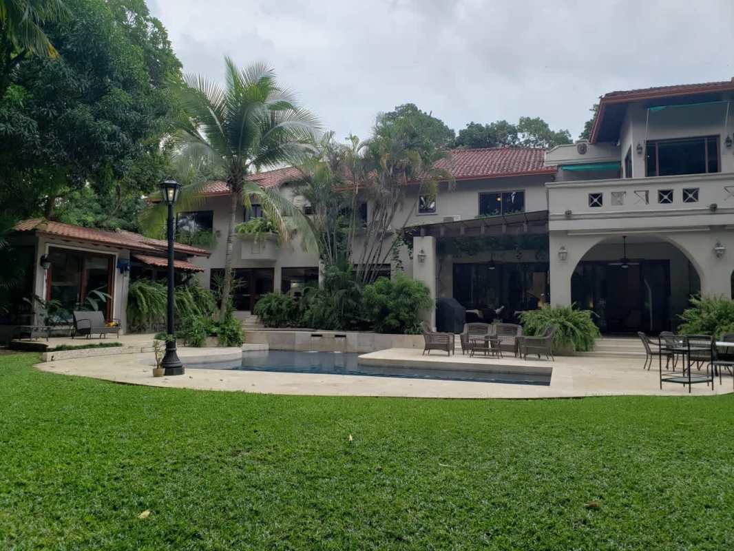 Spacious luxury kitchen with marble counters, island, stainless appliances in Altos del Golf mansion