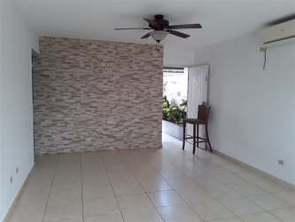 Spacious living room with stone accent wall, tile floors, ceiling fan and AC in Costa Verde Panama