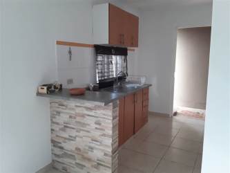 Kitchen with wood cabinets, tile backsplash, breakfast bar in rental house Panama Oeste