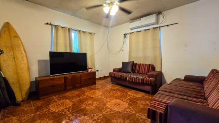 Living room with striped sofas ceiling fan air conditioning Cambutal Panama house sale