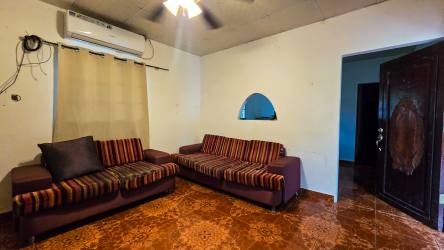 Family room striped sofas TV ceiling fan AC Cambutal Panama property
