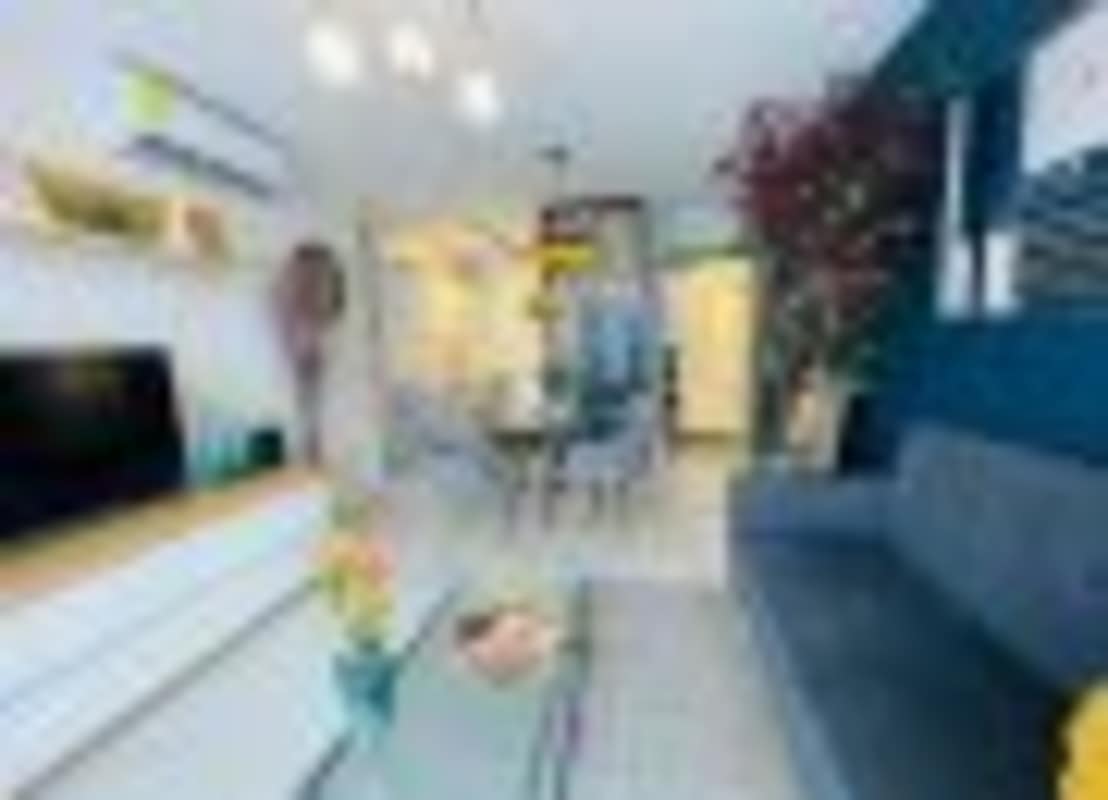 Modern living and dining room with blue accent wall, TV, open layout in PH Demetra Parque Lefevre Panama