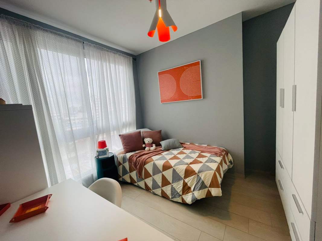 Second bedroom with large window, wardrobe and modern decor in PH Demetra Parque Lefevre