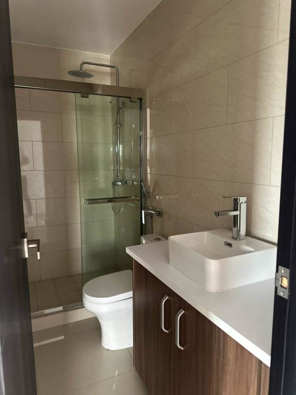 Unfurnished bedroom with tile floors and large window in PH Vicky Village apartment Panama City