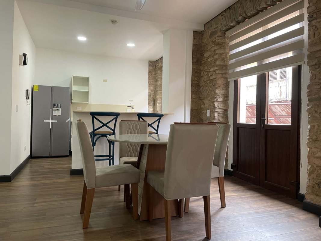 Bedroom with wooden flooring, built-in wardrobe and stone accents in Casco Viejo Panama