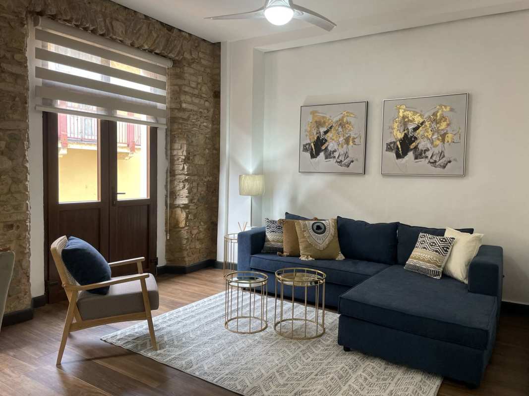 Spacious living area with exposed stone wall and balcony Casco Viejo Panama