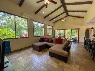 Kitchen with granite counters, island, modern appliances and terrace access in Penonomé house
