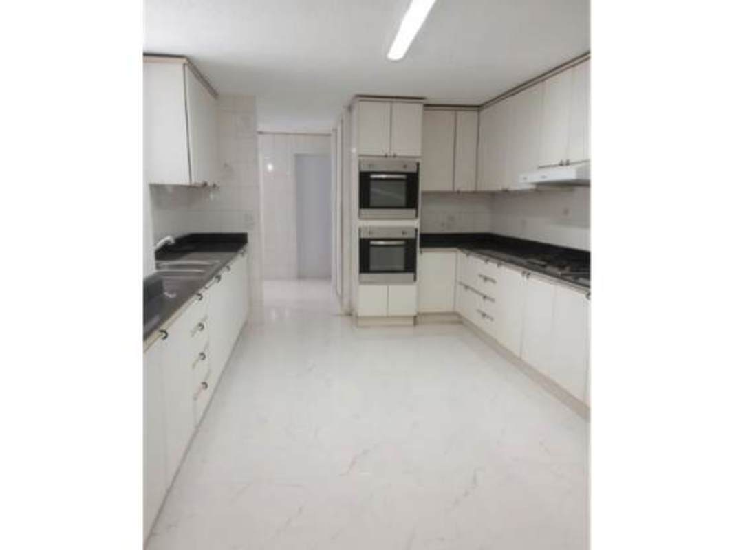 Kitchen with granite countertops and appliances in PH Tamanaco Punta Paitilla apartment for sale
