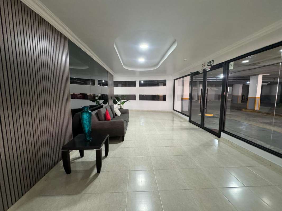 Spacious sunroom enclosed patio with lounge chairs in Golden Boulevard apartment Panama