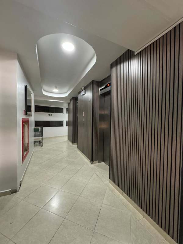 Modern building hallway with elevators wood panel walls Golden Boulevard Panama