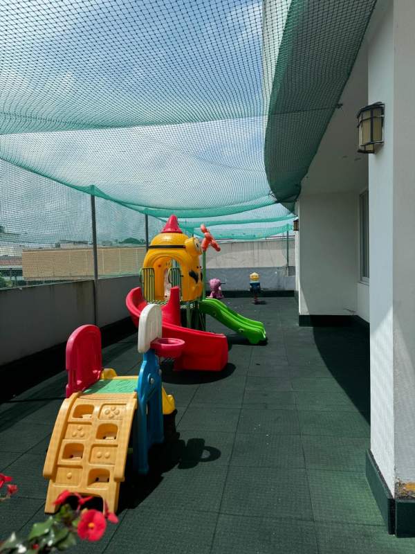 Children's play area outdoor balcony with colorful equipment Golden Boulevard Panama