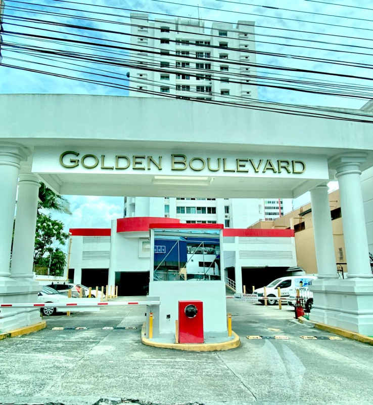 Building lobby with gray sofa, large glass doors in PH Golden Boulevard Panama