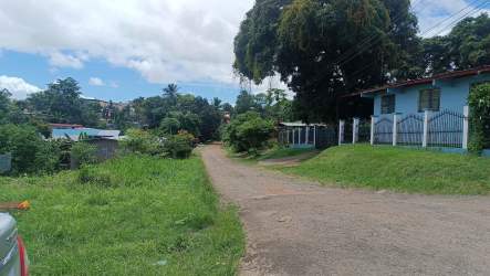 Rural neighborhood street with houses, fences, trees near La Seda Barrio Balboa