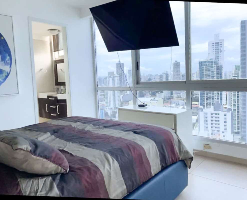Bedroom with city skyline views at PH Vista Balboa Panama City apartment