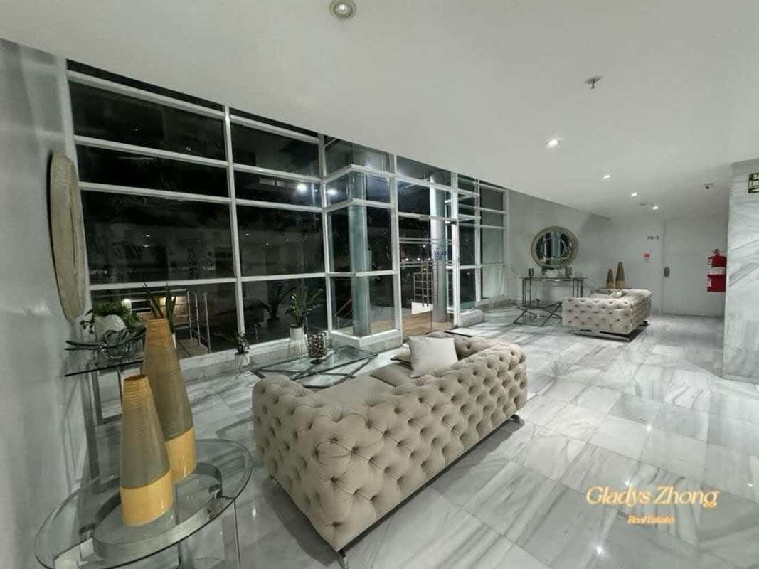 Contemporary lobby with marble floors glass walls sofas in PH Elmare Plaza Edison