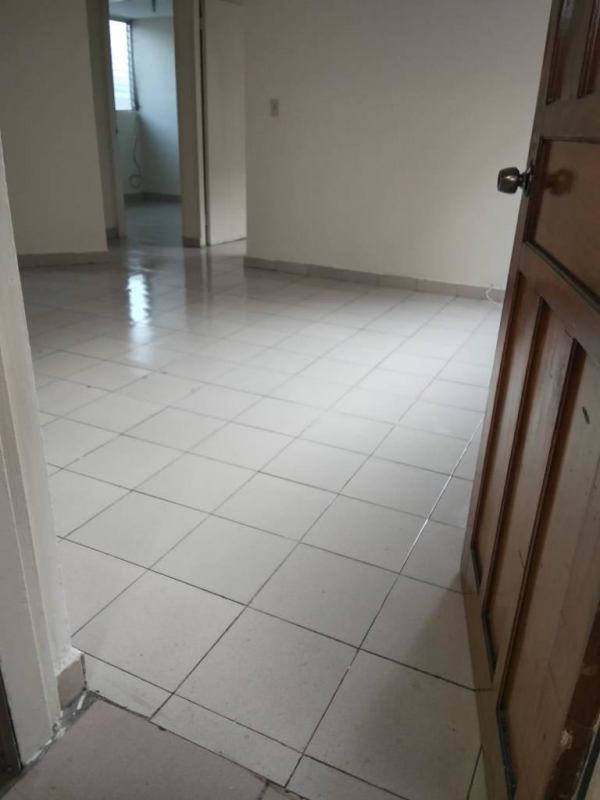 Empty living room with white walls and ceramic tiles Villa del Carmen Panama