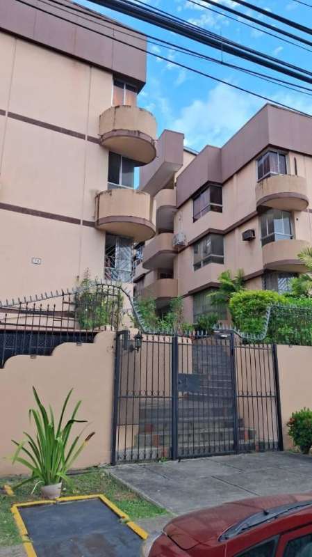 Multi-story apartment complex with balconies and gated entrance Panama City