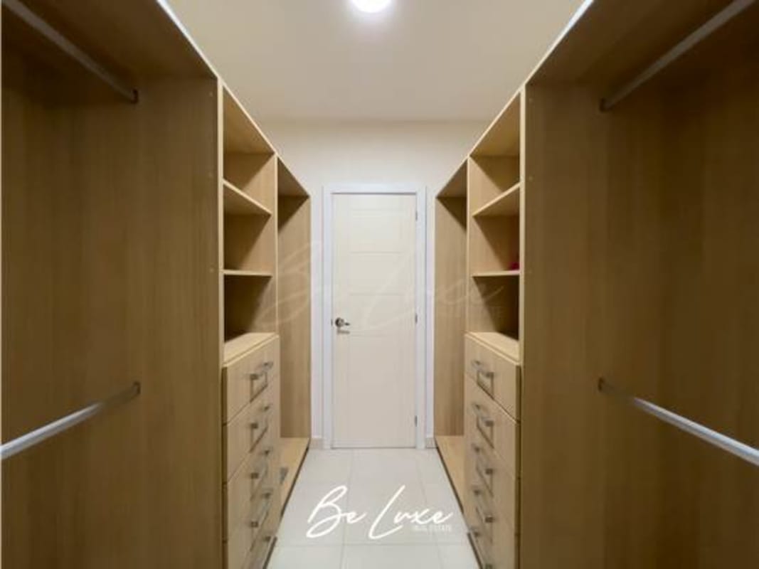 Second bedroom with built-in closet, city view window in luxury apartment at Waters On The Bay Panama