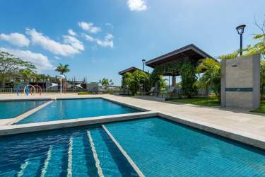 Multiple outdoor swimming pools with gazebos in River Valley Panama Pacifico