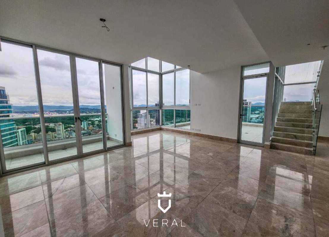 Terrace with glass railings offering panoramic views of Panama City skyline and Pacific Ocean from PH Costanera Bella Vista