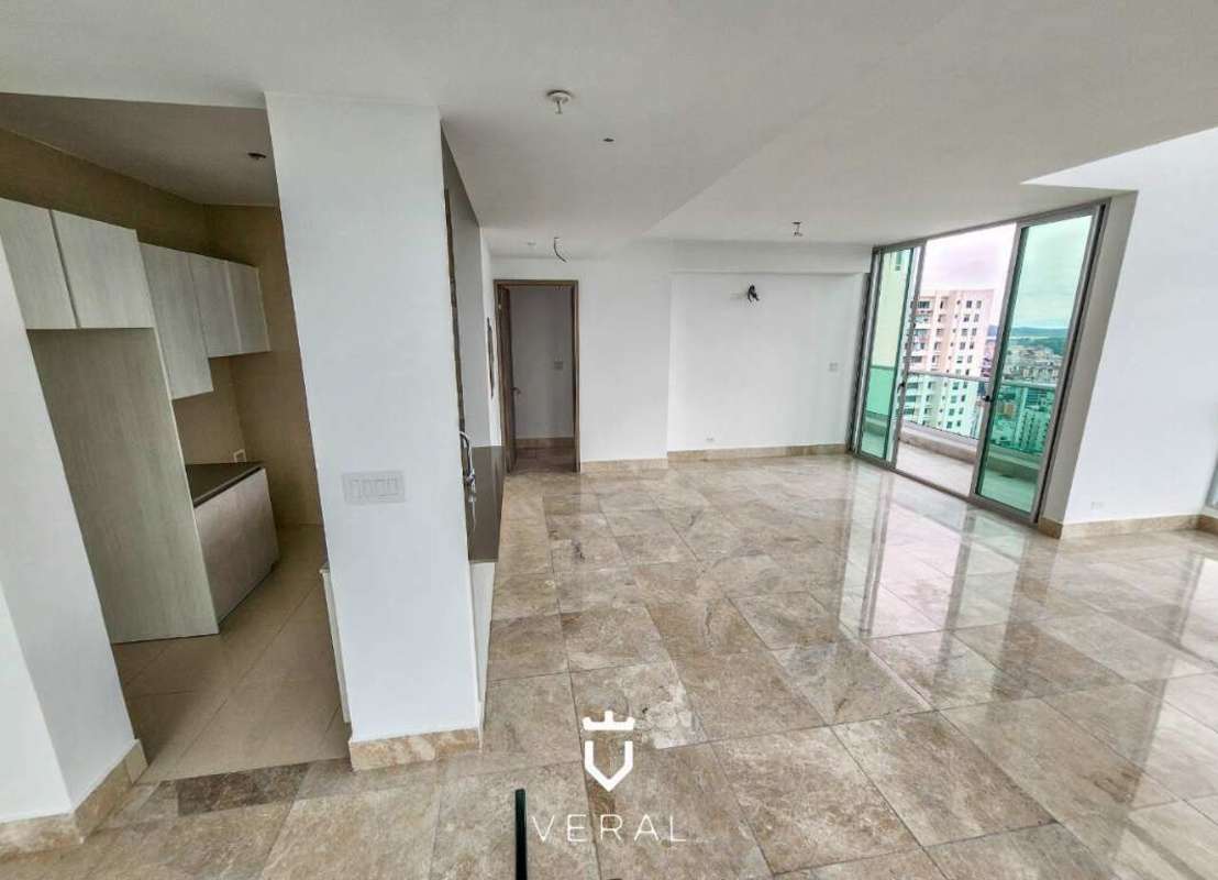 Rooftop infinity pool with sun deck overlooking city skyline and ocean at PH Costanera Bella Vista Panama