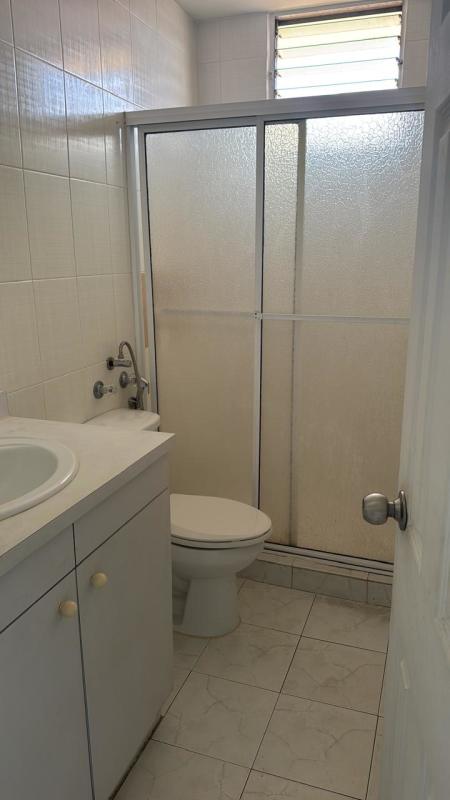 Empty bedroom featuring ceiling fan fixture, large window with city view at PH Miraflores Betania Panama City