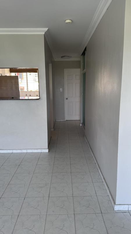 Modern kitchen with granite countertop, wood cabinetry, tiled backsplash in PH Miraflores Betania Panama City