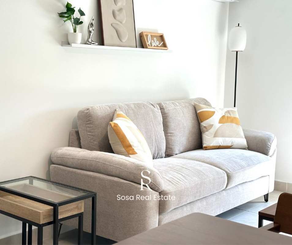 Minimalist lounge area with grey sofa and modern decor at Parque Lefevre Panama