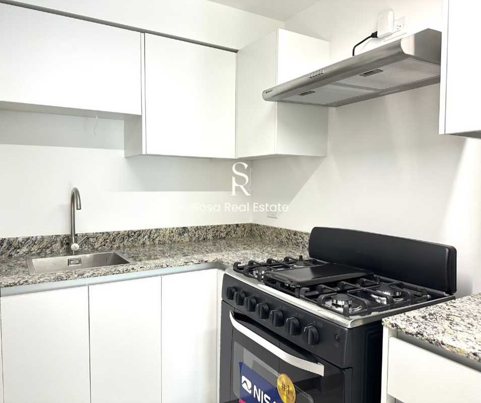 New kitchen with granite countertop and appliances at Parque Lefevre Residences Panama