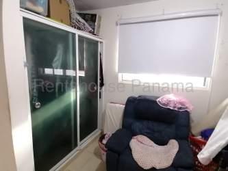 Minimalist bedroom with window, pink tones and simple furnishings in rental house La Chorrera Panama