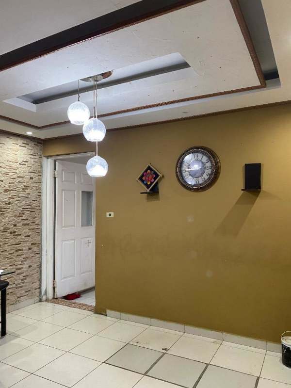 Bedroom with striped accent wall, AC unit, large window and tiled floor in corner house Villa Zaita