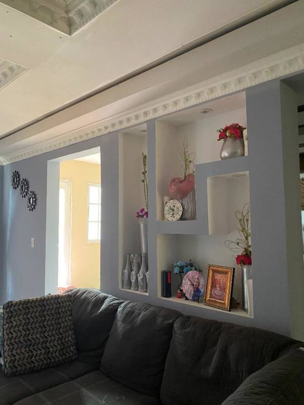 Large living room with tray ceiling, ceramic tile flooring, and sectional sofa in Villa Zaita Panama