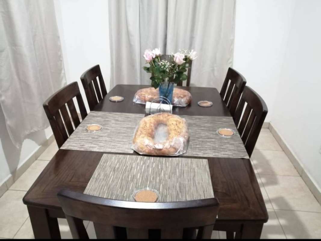 Dining room with wooden table, neutral decor Villa Verona house 24 de Diciembre Panama
