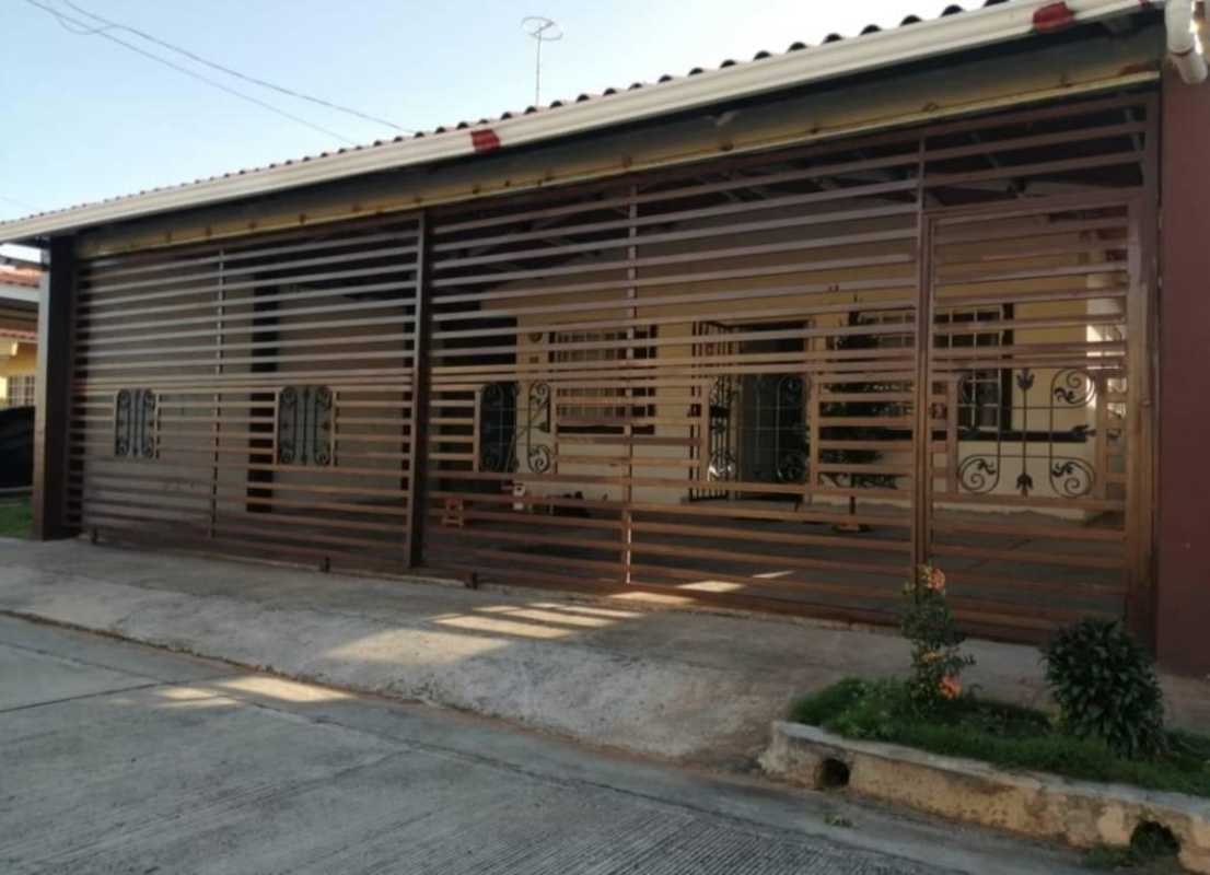 Exterior of house with metal security gate and tiled roof Villa Verona 24 de Diciembre Panama City