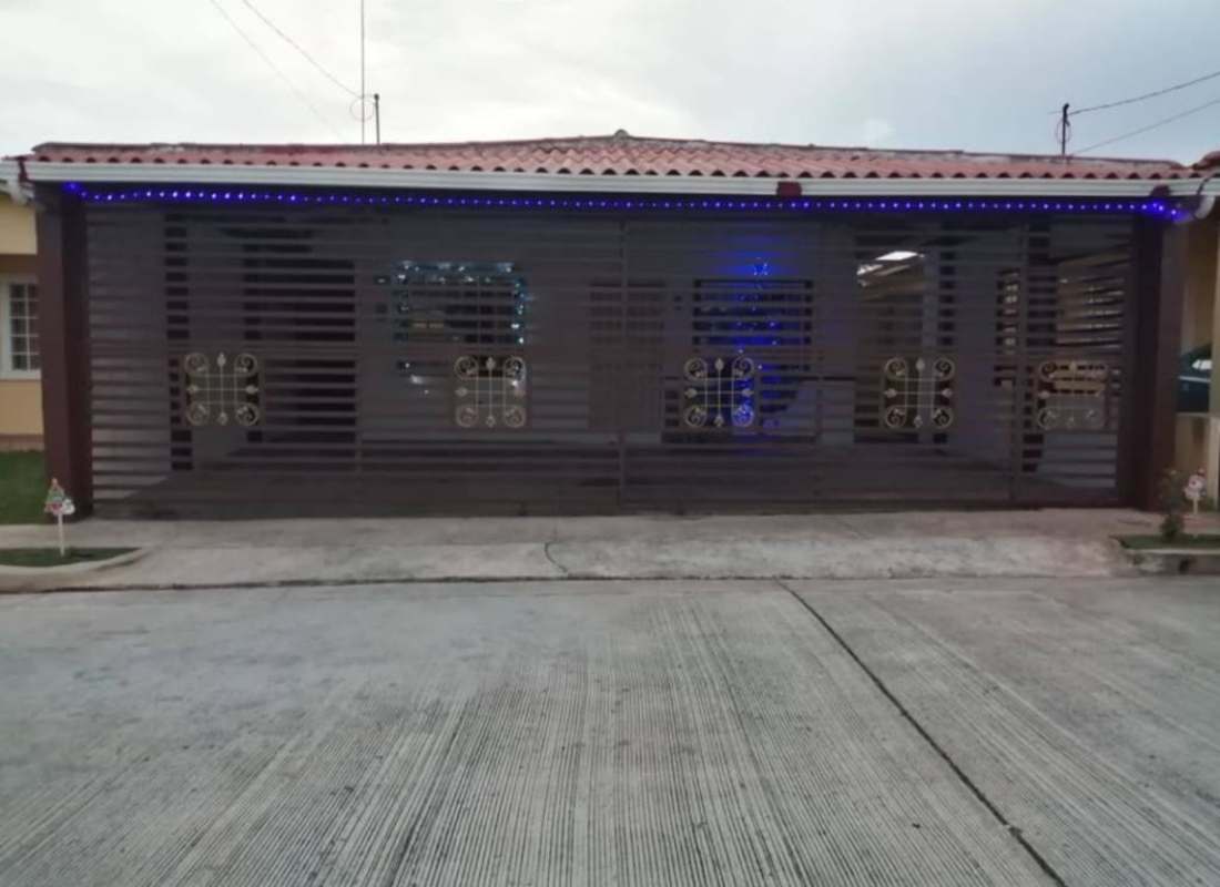 Night view with security gate tiled roof and lights Villa Verona Panama