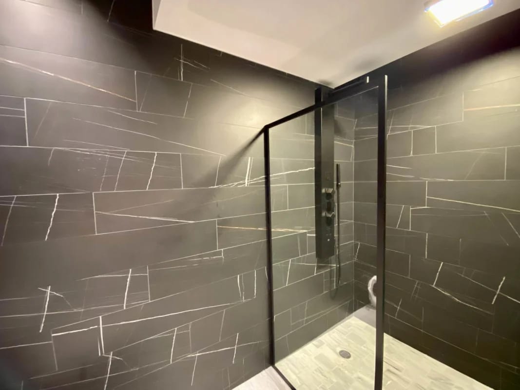 Stylish bathroom with walk-in glass shower and mosaic tiles PH Nuovo by Armani Casa Panama