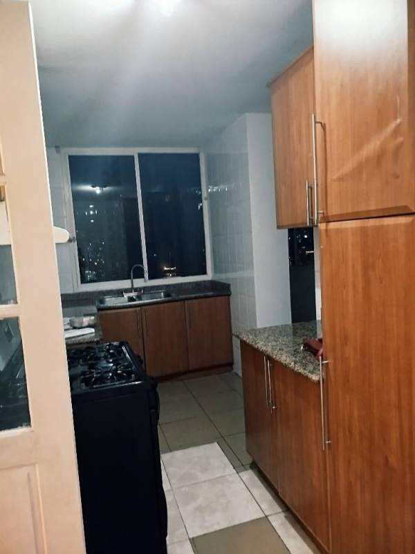 Minimalist bedroom with large window, ceiling fan, TV stand, city view at PH Torre El Cangrejo Panama