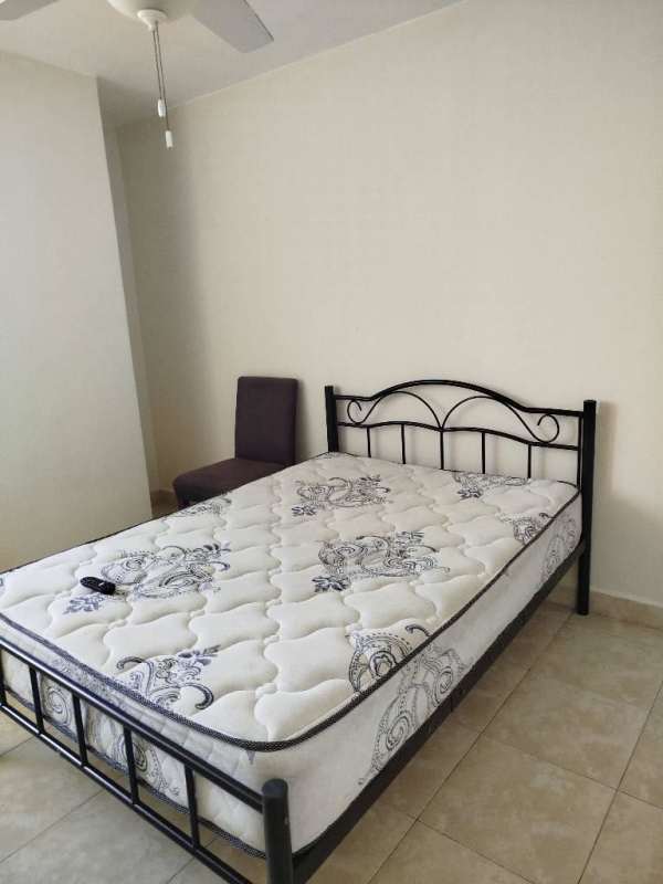 Minimalist bedroom with ceiling fan, metal bed frame, upholstered chair in PH Torre El Cangrejo Panama