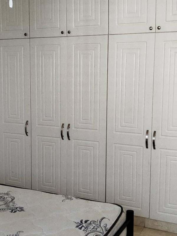 Bedroom with ample built-in wardrobes, tile flooring and natural light at PH Torre El Cangrejo Suites Panama