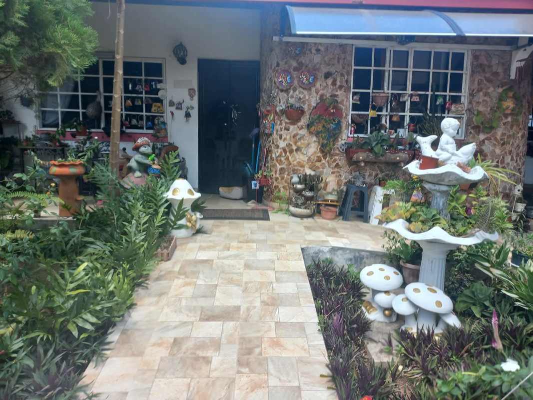 Stone facade, landscaped garden with sculptures Villa Zaita Panama house for sale