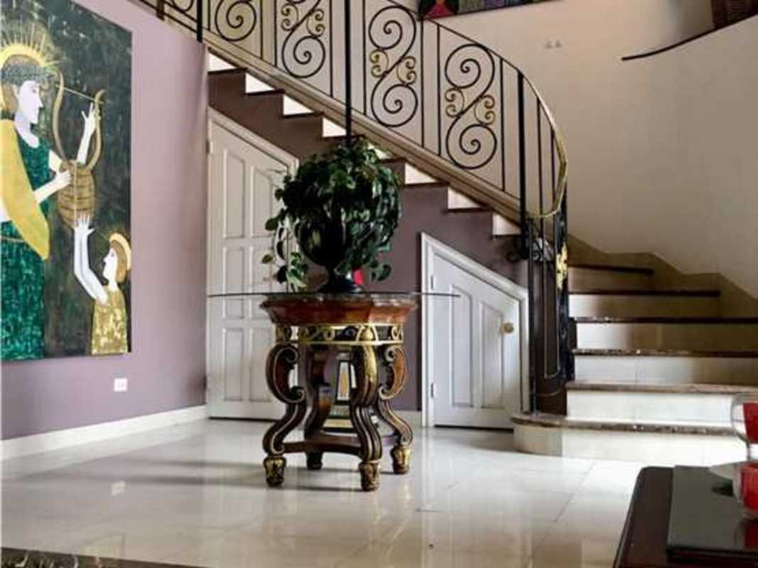 Traditional kitchen with granite counters, island, wood cabinetry in PH Costa Bay Costa del Este Panama City