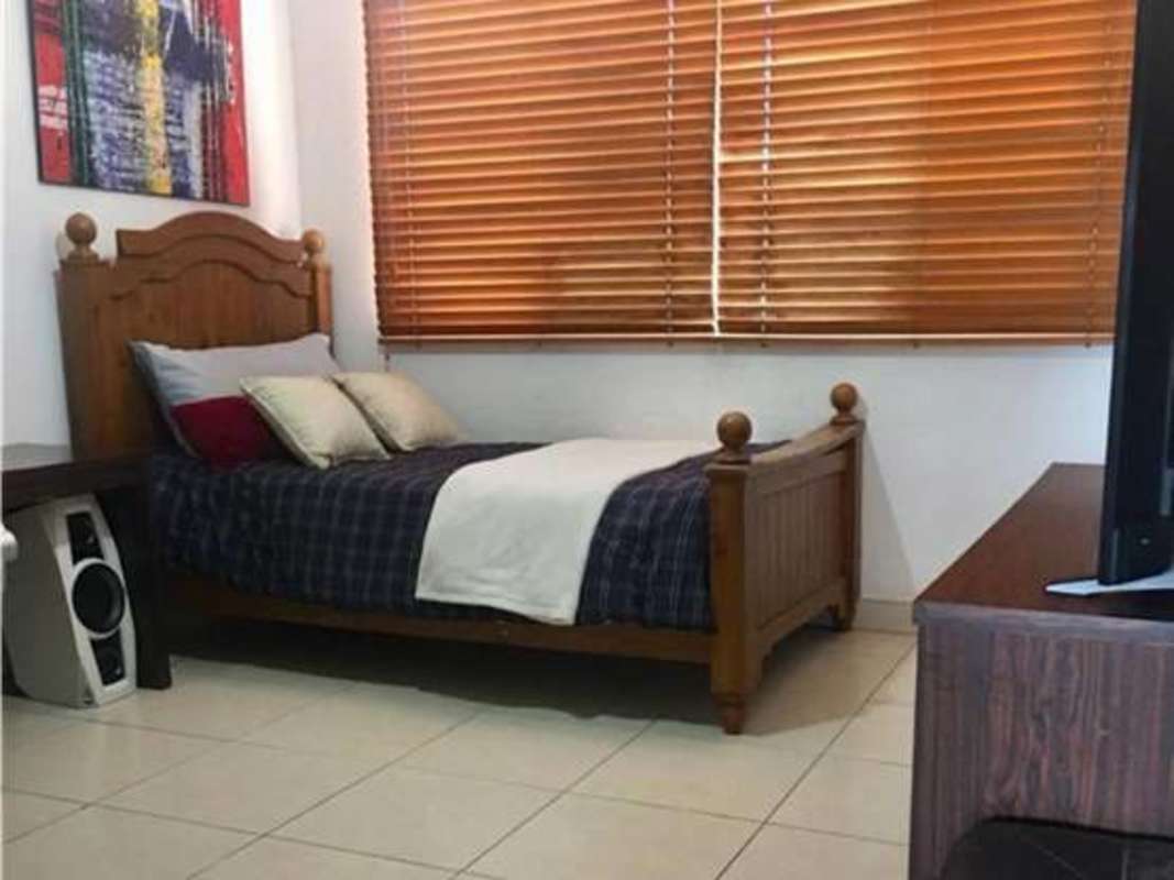 Living room featuring wicker seating, glass doors, large window in PH Costa Bay Costa del Este