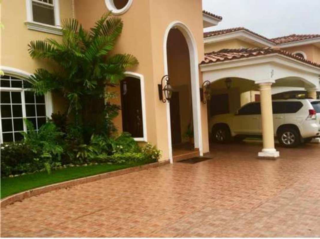 Spacious foyer with intricate staircase, decorative railing and artwork in Costa del Este luxury house