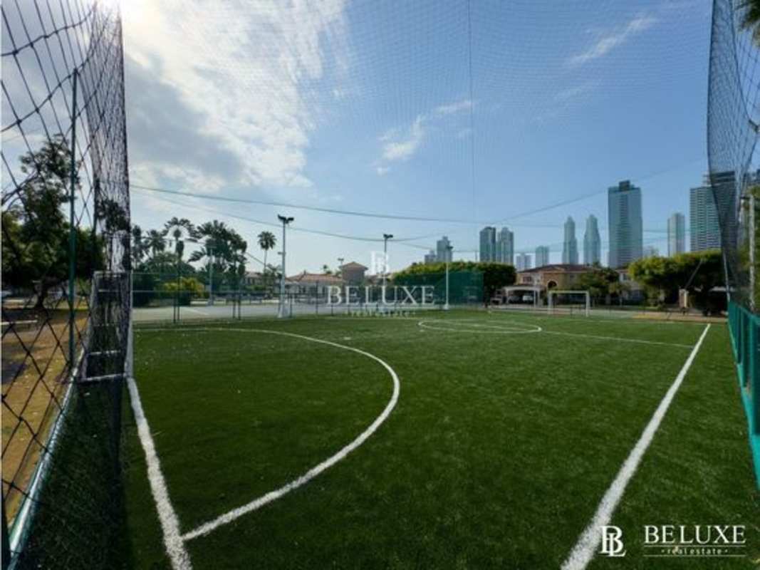 Cozy bedroom with wood blinds, tiled floor and colorful bedding in PH Costa Bay Costa del Este Panama