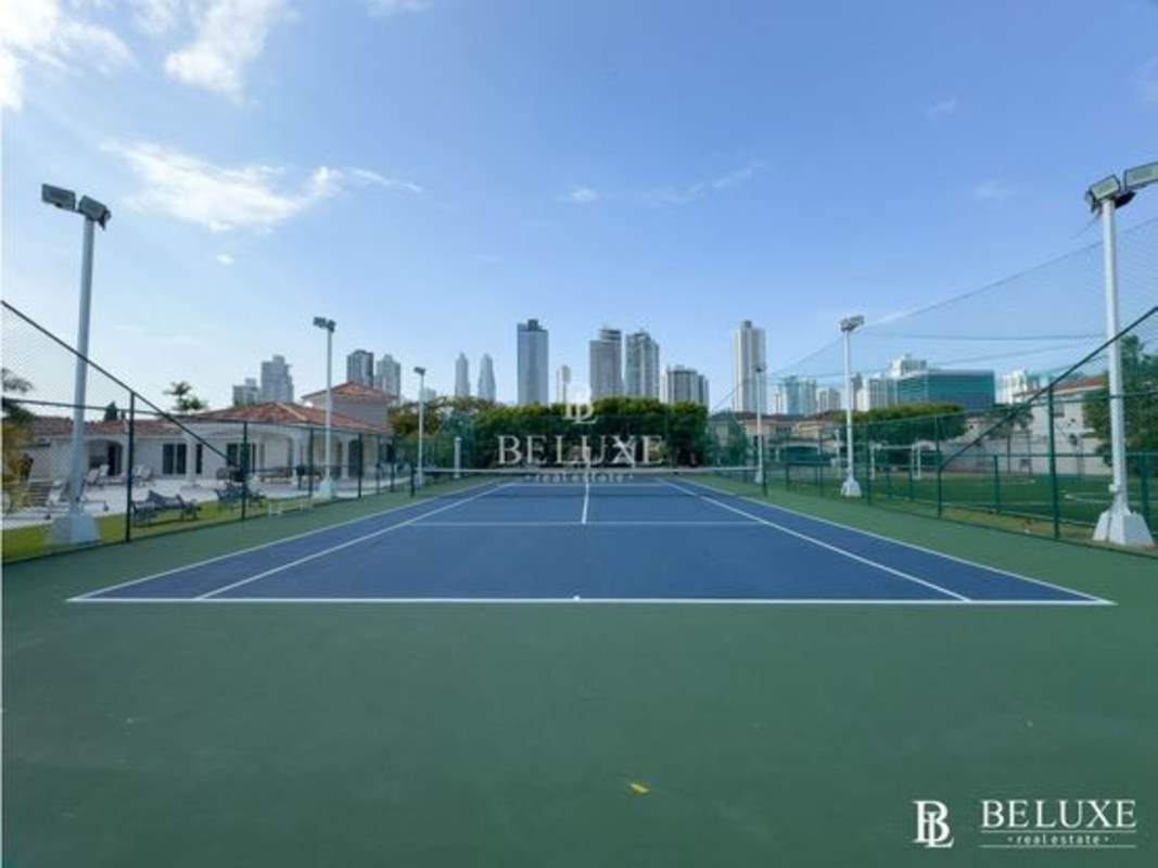 Tennis court with fence, lighting and skyline at PH Costa Bay Costa del Este Panama