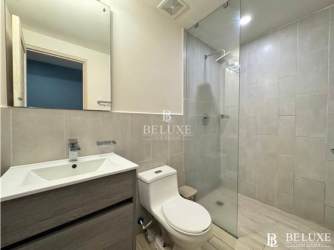 Contemporary bathroom with glass-enclosed shower and vanity in Playa Caracol condo